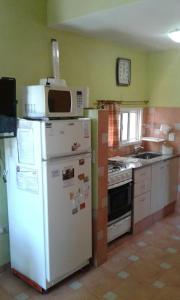 a kitchen with a microwave on top of a refrigerator at Departamentos Suyana in Colón