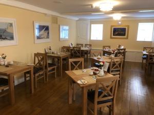 a dining room filled with tables and chairs at Almorah Hotel in Saint Helier Jersey