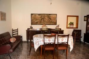 a living room with a table and a couch at Silia's Maisonette in Marsaskala