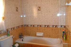 a bathroom with a bath tub and a toilet at Silia's Maisonette in Marsaskala +62 photos