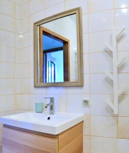 a bathroom with a sink and a mirror at Kaminkelio apartment 44 in Vilnius