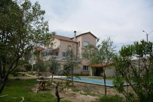 a villa with a swimming pool and a house at L'Oiseau Bleu in Tournon-sur-Rhône