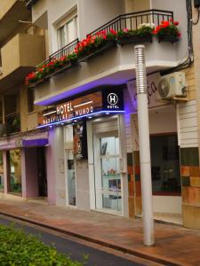a building with a sign for a hotel on a street at Hotel Maravillas del Mundo in Calpe