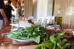 a table with a plate of greens on top of it at Plaj Hotel in Cıralı