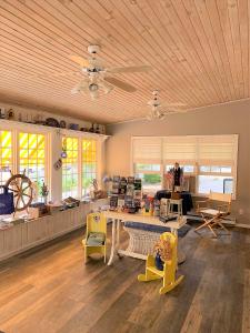 a large living room with a table and chairs at Admiral Motel in Lake George