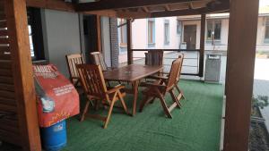 a wooden table and chairs on a porch at Inter Hostel Liberec in Liberec