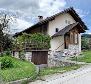 a house with a wooden door and a balcony at House Amalia in Bled