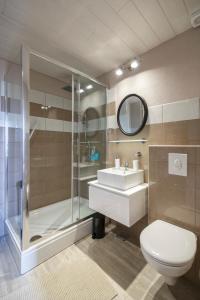 a bathroom with a shower and a toilet and a sink at Apartments Mardešić in Komiža