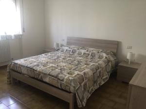 Tempat tidur dalam kamar di LA CALANDIVA DEL CONERO