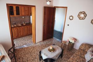 a living room with a table with a candle on it at Roxanne’s Home in Limenas +43 photos