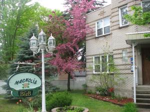 a street light in front of a house with a sign at Magnolia B&B in Granby