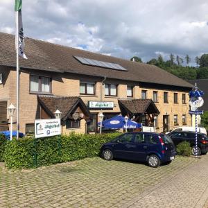 a blue car parked in front of a building at Landgasthaus Jägerhof in Büren