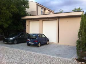 
a car parked in front of a house at Guesthouse Liska in Mostar
