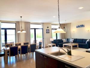 a kitchen and living room with a couch and a table at Private seaview villa in BlackSeaRama - 1st line in Balchik