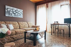 a living room with a couch and a table at Roxanne’s Home in Limenas