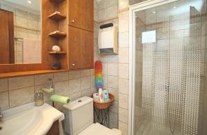 a bathroom with a shower and a toilet and a sink at Villa Sanni Retreat by Luxlikehome in Sani Beach +36 photos