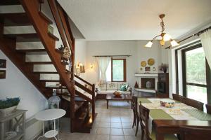 a kitchen and dining room with a table and a staircase at Villa Sanni Retreat by Luxlikehome in Sani Beach