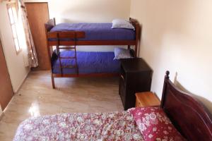 a bedroom with two bunk beds in a room at hostal iquisa in San Pedro de Atacama