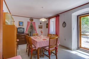 a dining room with a table and chairs at CASA OLIVA in Sveti Jakov