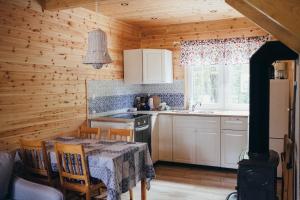 a kitchen with a table and a stove at Tumiło in Dziwnów