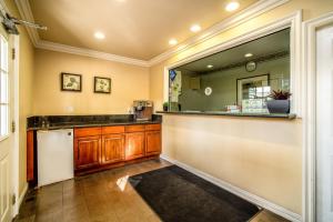 a kitchen with a counter and a large mirror at Regency Inn & Suites Downey in Downey