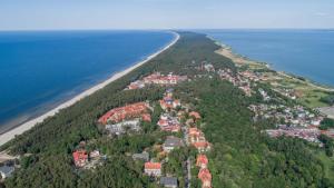 an island in the ocean next to a beach at Apartament Comfort Kahlberg in Krynica Morska