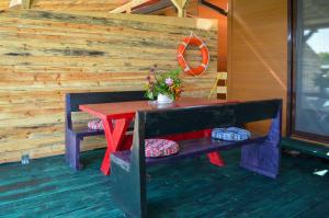 a table and bench on the porch of a cabin at Baraka in Ulcinj