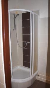 a shower with a glass door in a bathroom at Ubytovací areál Rouchovany in Rouchovany