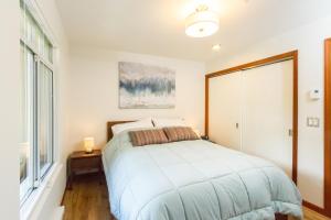um quarto com uma cama e uma janela em 63 Lagoons em Whistler