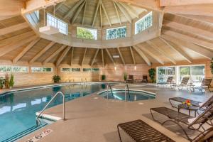 an indoor pool in a building with a large ceiling at Ashbrooke Hotel in Egg Harbor
