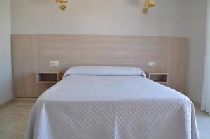 Łóżko lub łóżka w pokoju w obiekcie Hotel Casa Portuguesa