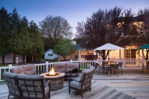 a patio with a fire pit and a table and chairs at Ashbrooke Hotel in Egg Harbor