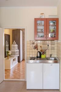 a kitchen with white cabinets and a sink at Devivi Apartments in Split