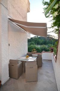 a patio with a table and chairs and an umbrella at Casa Maria in Camaiore