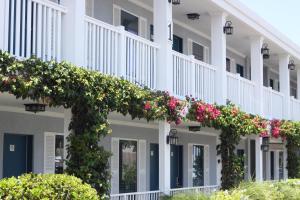 a large white building with flowers on it at Southern Oaks Inn - Saint Augustine in Saint Augustine
