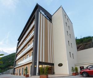 a building with a red car parked in front of it at Grand Mela Hotel in Macka