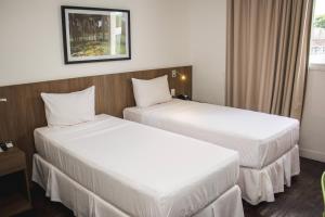 Cama ou camas em um quarto em Nobile Hotel Belo Horizonte