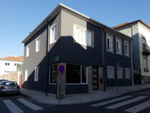 a black and white building on the side of a street at Porto Concept Home - University Residence & Guesthouse - Pólo II Paranhos in Porto