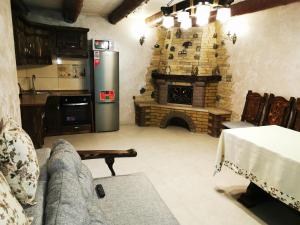 a living room with a couch and a fireplace at Ilkova Sadyba in Yaremche