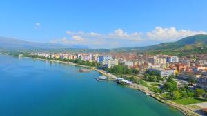 an aerial view of a river with a city at British Hotel Pogradec in Pogradec