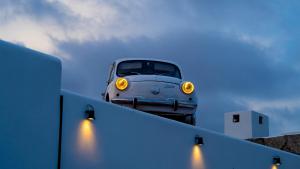 a car sitting on the top of a wall at PAIISE Hotels in Sant Francesc de s'Estany