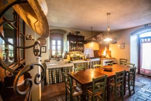 una cucina con tavolo in legno e una sala da pranzo di Il Vichiaccio Country House a Impruneta
