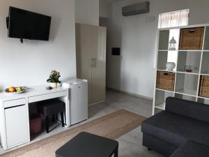 a living room with a desk and a couch at Deluxe Lipari Room in Lipari