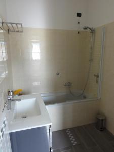 a bathroom with a sink and a shower and a tub at Luxury Apartment Lake Como in Acquaseria +33 photos