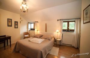 a bedroom with a bed and a table and a window at L'Atterrissage in Santes