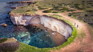 an aerial view of a cave in the ocean at Hybla Major B&B in Avola