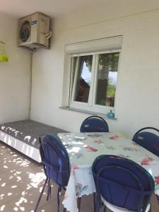 a room with a table and chairs and a bed at Apartment Skale in Senj