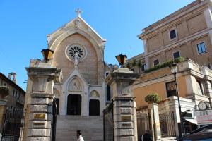 a church with a gate in front of a building at Chez Liviana in Rome