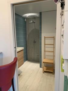 a bathroom with a shower with blue tiles at Villa kahlo Omaha Beach in Colleville-sur-Mer +30 photos