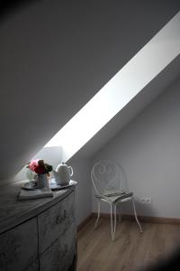 a white room with a table and a chair at Belle Vue Terrasse in Giverny +15 photos